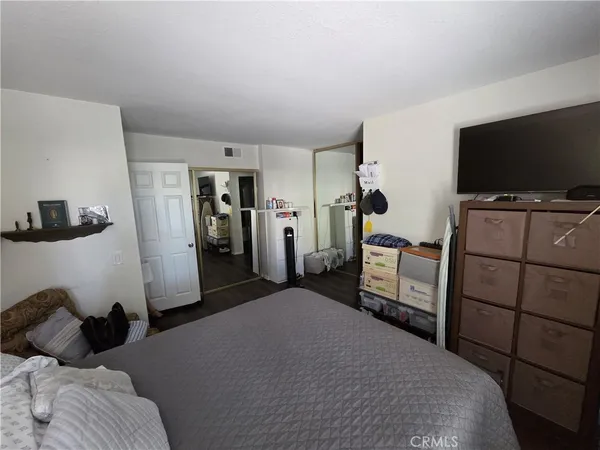 a bedroom with a bed and a flat screen tv