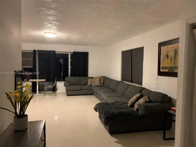 a living room with a fireplace and a rug