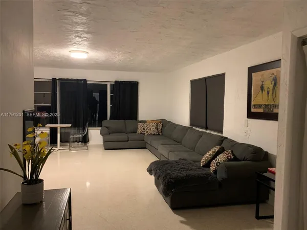 a living room with a fireplace and a rug