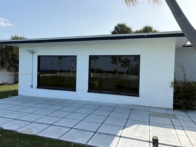 a terrace with a sink and chairs