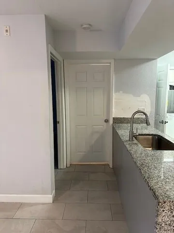 a kitchen with a sink and a refrigerator