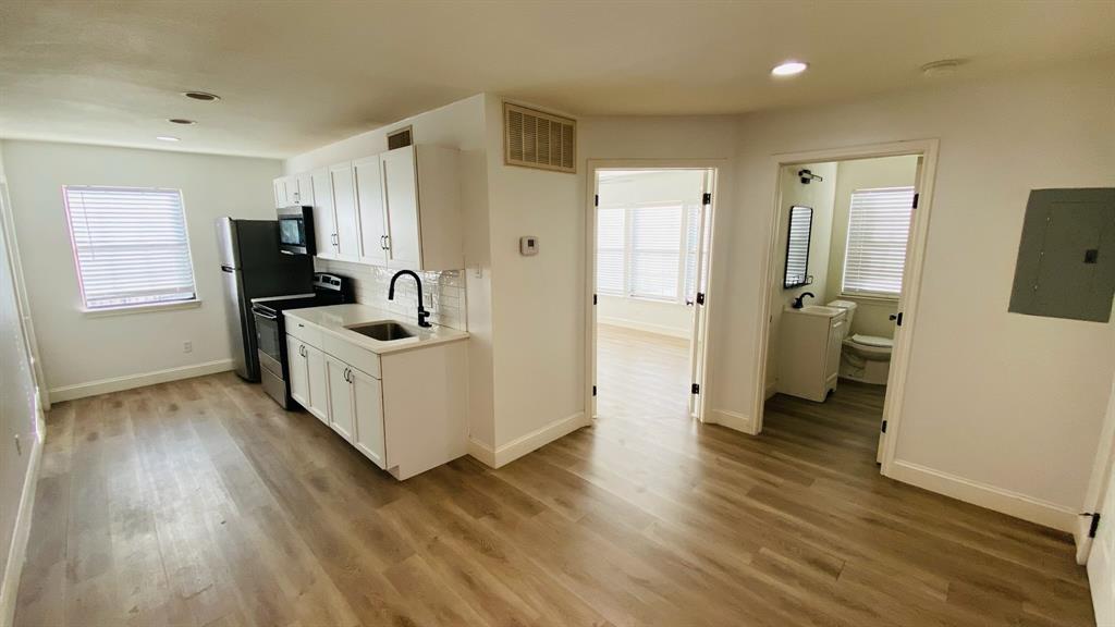 5003 Bryan Street, Unit 6 Dallas, TX 75206 - Photo 3 of 9 a view of living room with furniture and wooden floor