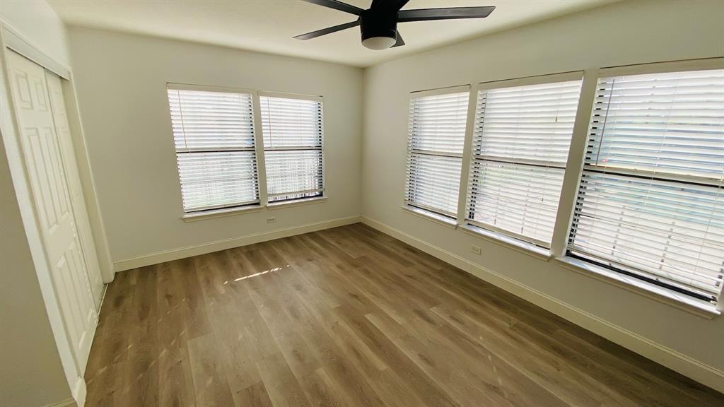 5003 Bryan Street, Unit 6 Dallas, TX 75206 - Photo 5 of 9 a view of an empty room with a window and wooden floor