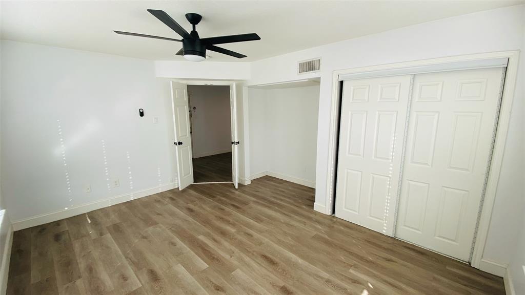5003 Bryan Street, Unit 6 Dallas, TX 75206 - Photo 7 of 9 a view of empty room with wooden floor and ceiling fan