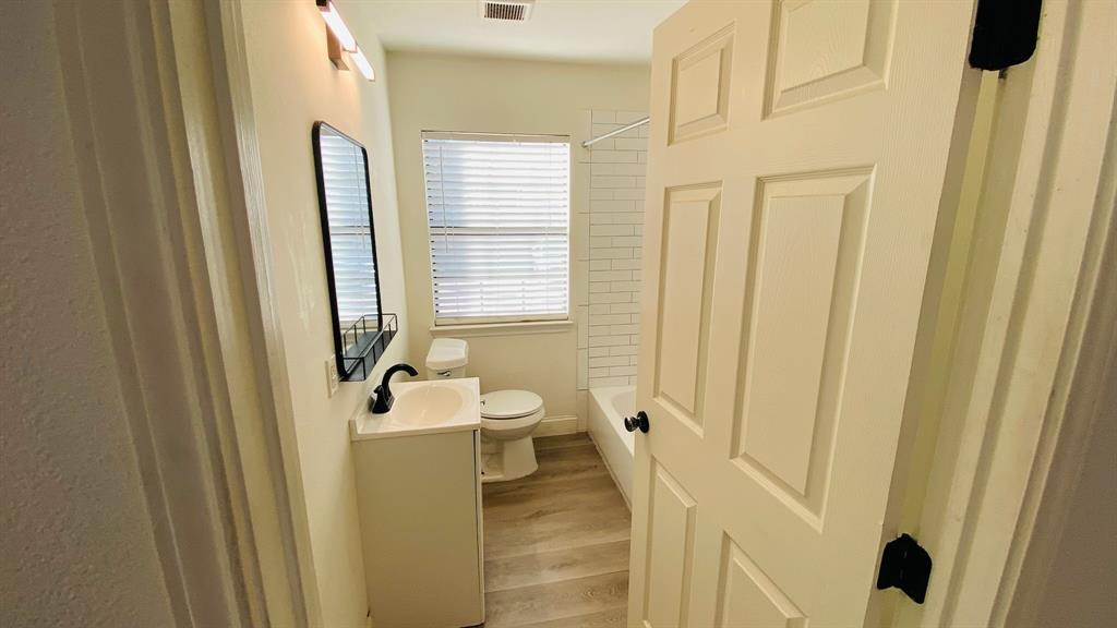 5003 Bryan Street, Unit 6 Dallas, TX 75206 - Photo 8 of 9 a bathroom with sink and mirror