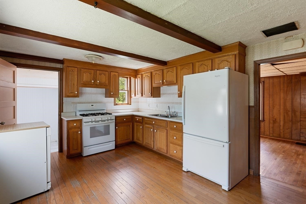 19 Butler Avenue Wakefield, MA 01880 - Photo 13 of 33 a kitchen with granite countertop appliances a sink and a refrigerator