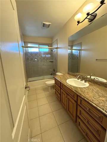 a bathroom with a granite countertop sink and mirror