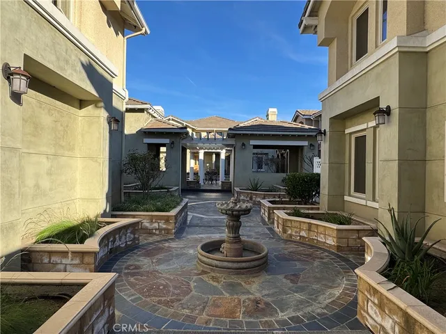 a front view of a house with garden and patio
