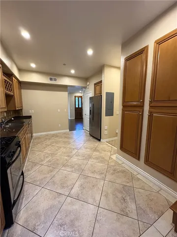 a view of a refrigerator in kitchen and a window