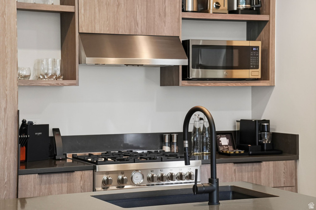 2417 West High Road, Unit 3210 Park City, UT 84098 - Photo 14 of 44 Gas range, vent hood and built-in microwave in the Pendry Park City kitchen.