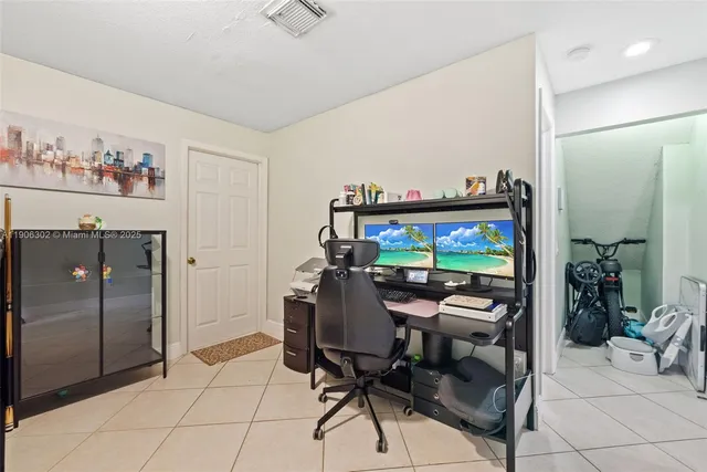 a view of a livingroom with furniture and a flat screen tv