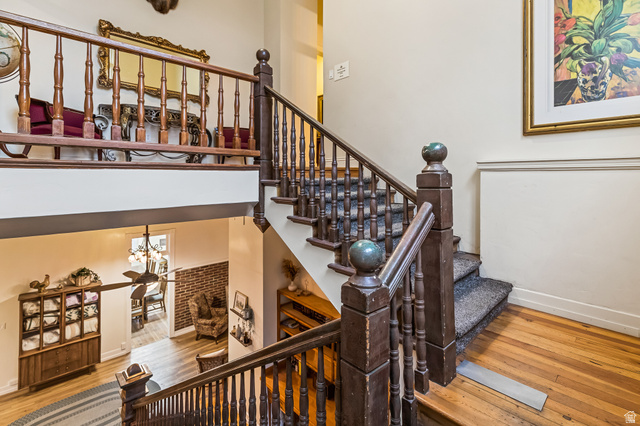 21 North Main Street Kingston, UT 84743 - Photo 53 of 107 Stairs with hardwood / wood-style floors, a high ceiling, and a chandelier