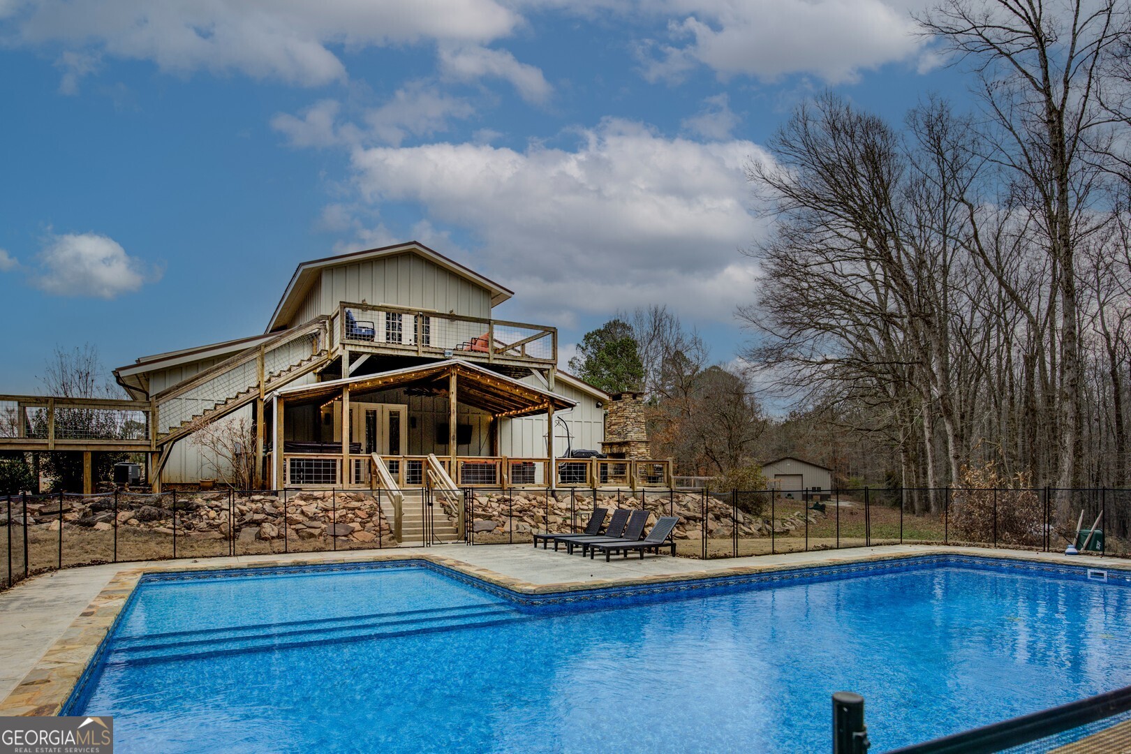 2049 Midway Church Road Newborn, GA 30056 - Photo 16 of 71 a front view of a house with swimming pool yard and outdoor seating