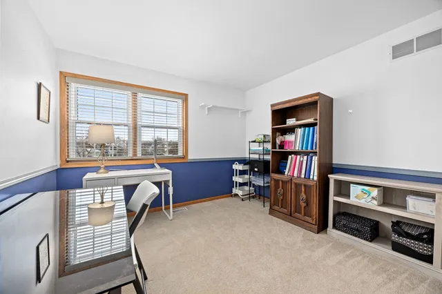 a livingroom with workspace and a window