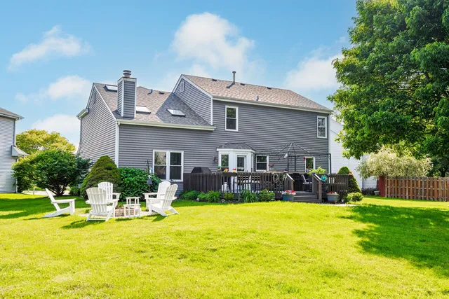 a view of a house with a swimming pool and sitting area
