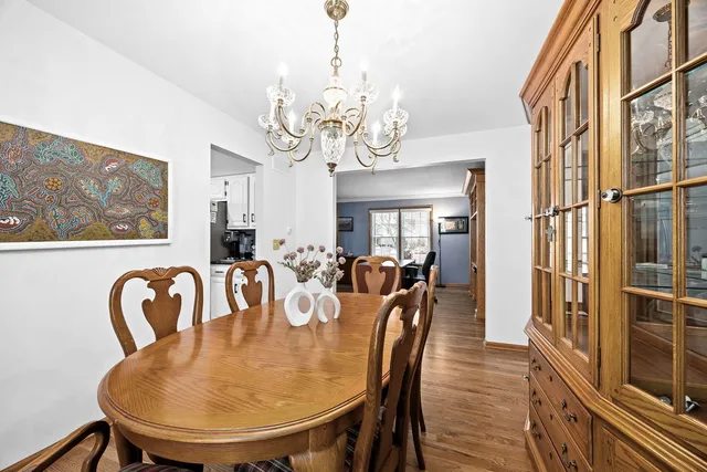 a view of a dining room with furniture and a chandelier