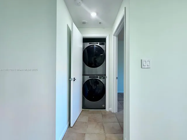 a view of a small space with wooden floor and a window