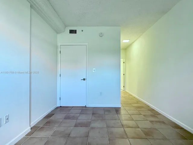 a view of a hallway with a white walls