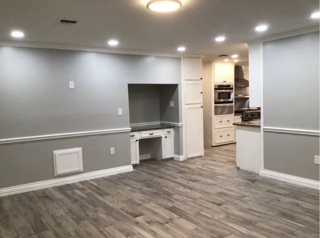 an empty room with wooden floor and closet