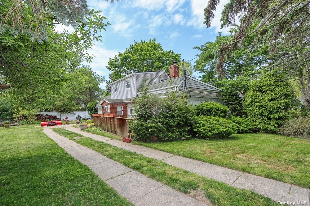 282 Edgewood Street Islip Terrace, NY 11752 - Photo 1 of 1 a front view of a house with a yard