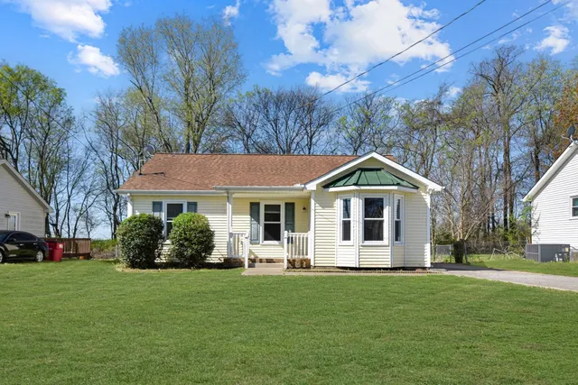a front view of house with yard and green space