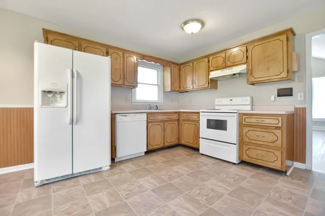 a kitchen with a stove a sink and a refrigerator