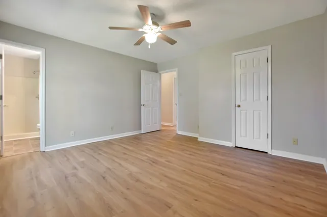 a view of an empty room with wooden floor