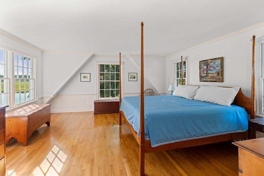 34 Sunset Road Duxbury, MA 02332 - Photo 22 of 42 a bedroom with a large window and a wooden floor