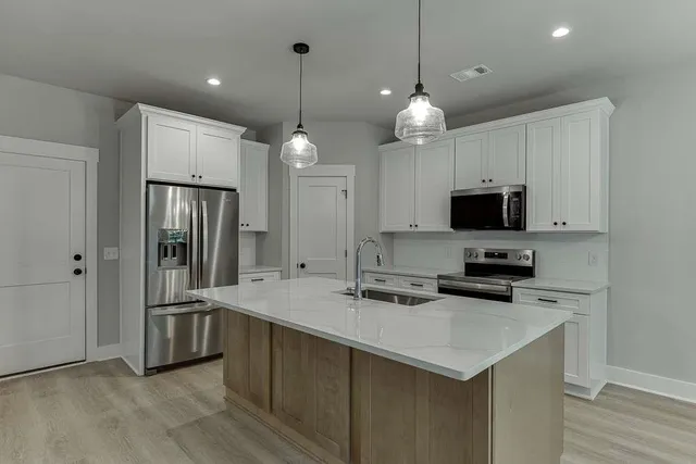 a kitchen with cabinets and stainless steel appliances