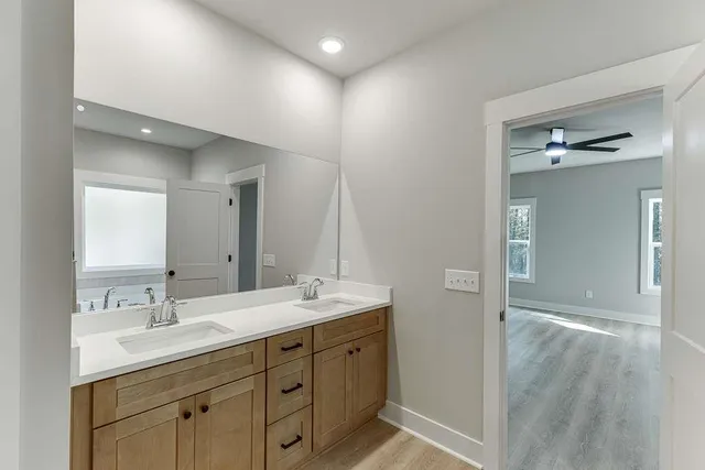 a bathroom with a double vanity sink and mirror