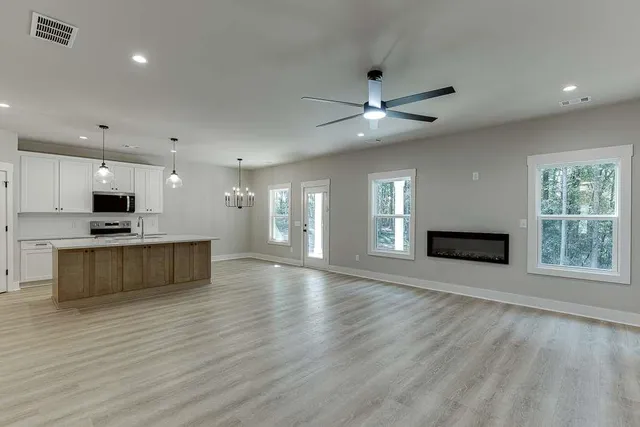 a view of kitchen with microwave and stove top oven