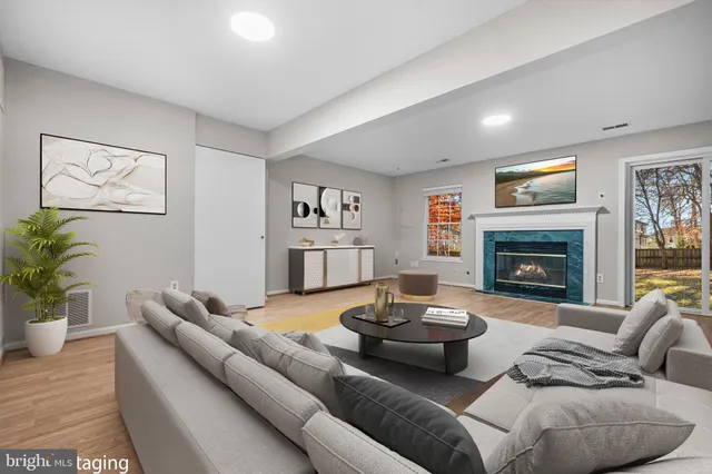 a view of empty room with wooden floor and fireplace