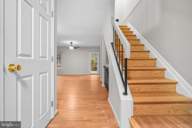 a view of entryway and hall with wooden floor