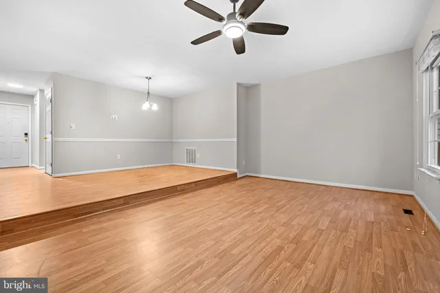 a view of an empty room and wooden floor