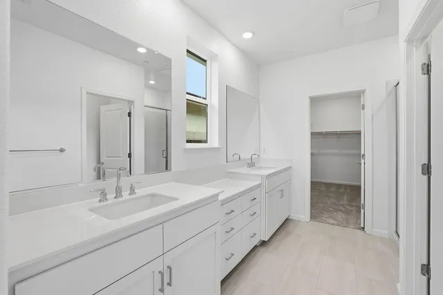 a bathroom with a double vanity sink and a mirror