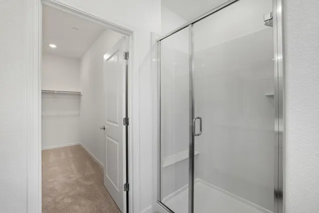 a bathroom with a shower and a glass door