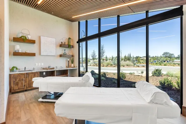 a backyard of a house with table and chairs