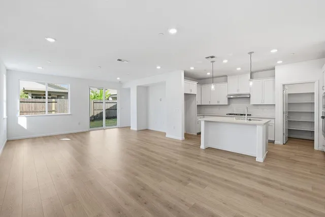 a view of kitchen with kitchen island sink and center island