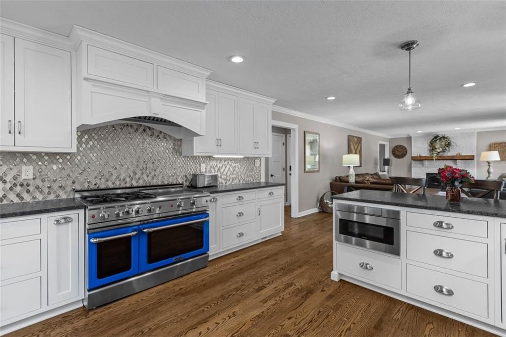 809 Timber Trail Oakdale, PA 15071 - Photo 11 of 50 a kitchen with stainless steel appliances white cabinets and a stove top oven