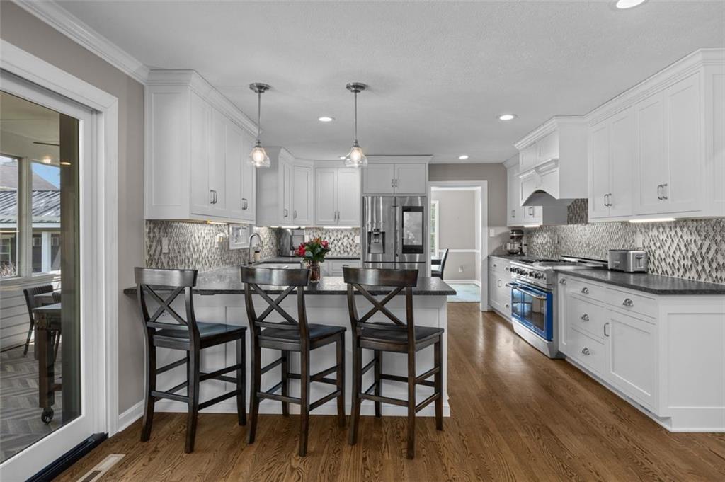 809 Timber Trail Oakdale, PA 15071 - Photo 14 of 50 a kitchen with granite countertop a table chairs microwave and cabinets