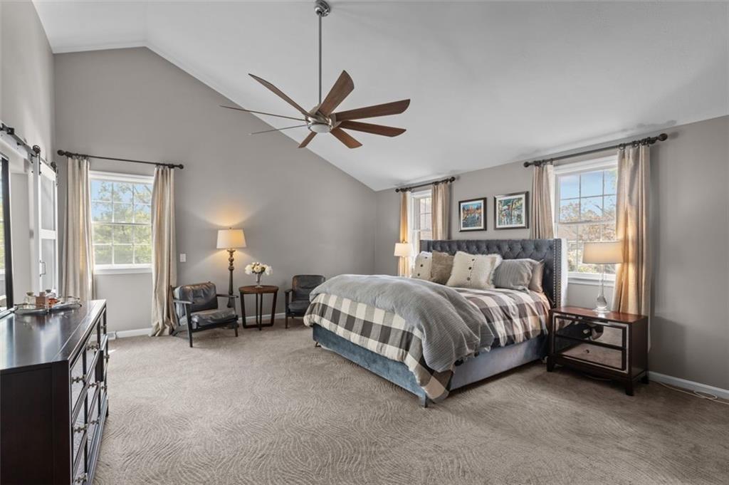 809 Timber Trail Oakdale, PA 15071 - Photo 27 of 50 a spacious bedroom with a bed and a chandelier