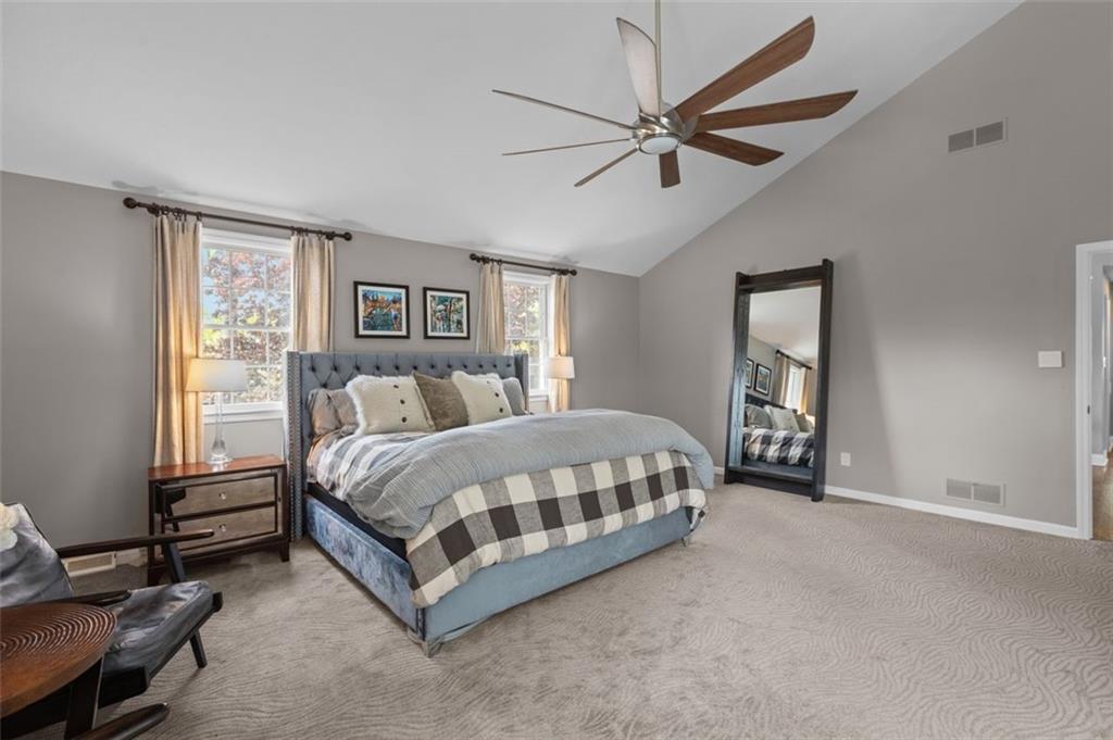 809 Timber Trail Oakdale, PA 15071 - Photo 28 of 50 a spacious bedroom with a bed a window and a chandelier