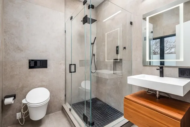 a bathroom with a toilet a sink and a shower