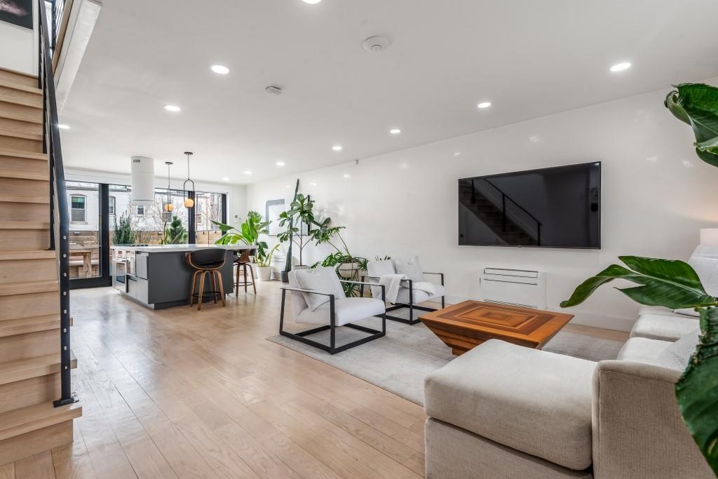 1712 Dekalb Avenue Brooklyn, NY 11237 - Photo 2 of 17 a living room with furniture and a flat screen tv