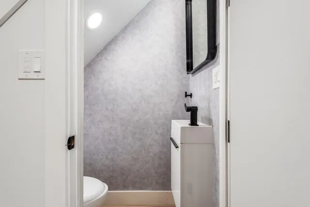 a bathroom with a toilet and a shower