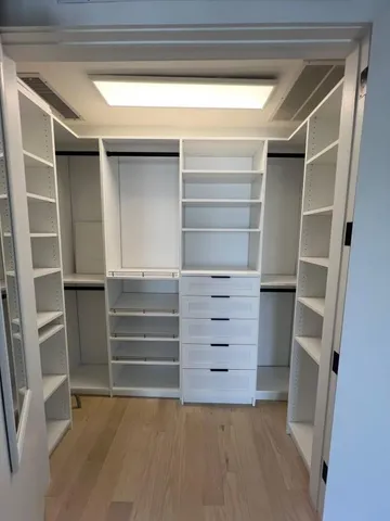 a room with walk in closet and stairs