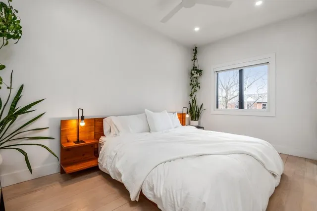 a bedroom with a bed and a window