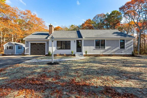 a house that has a tree in front of it
