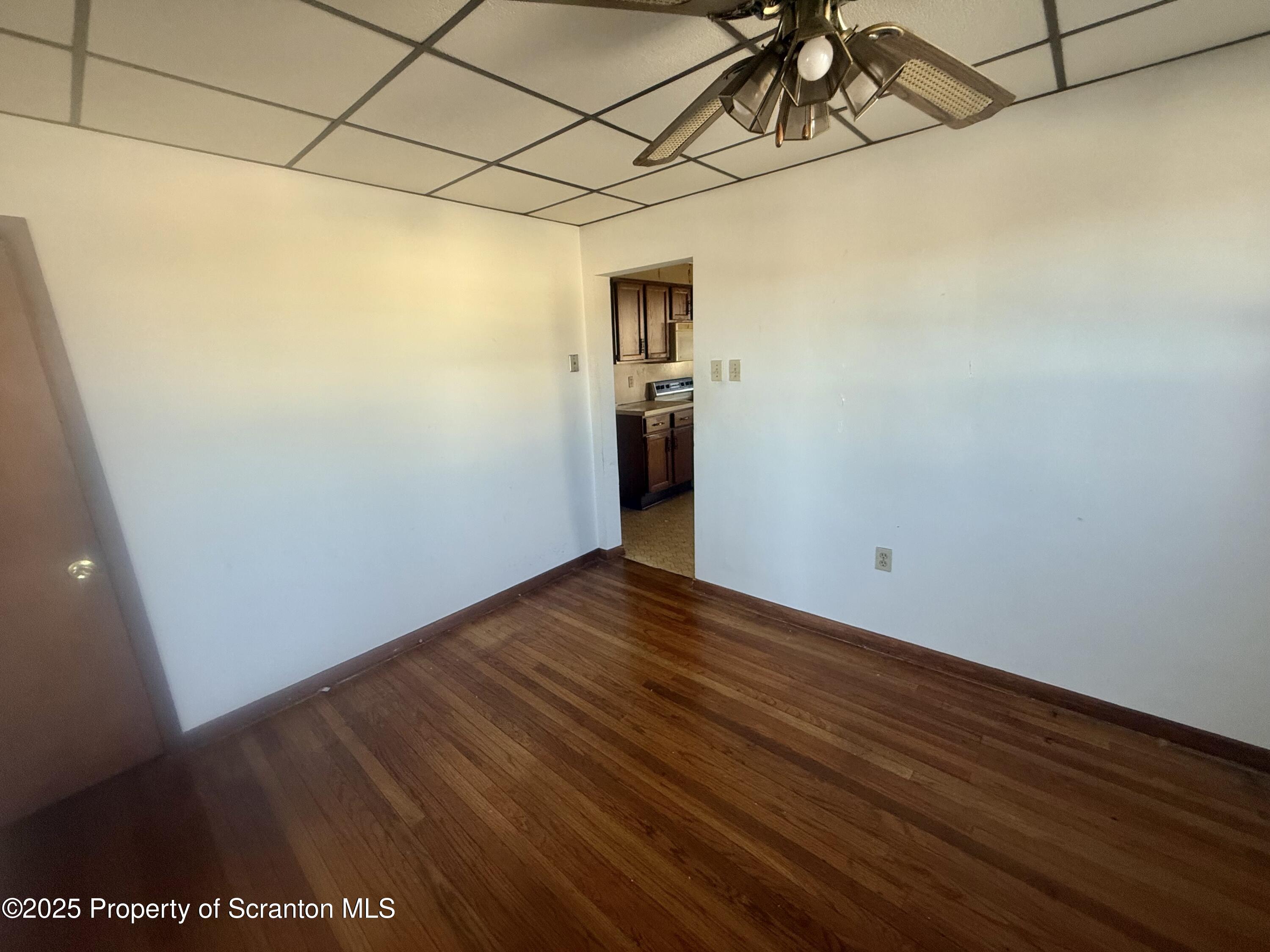 662 Simpson Street Throop, PA 18512 - Photo 3 of 9 a view of a room with wooden floor and entryway