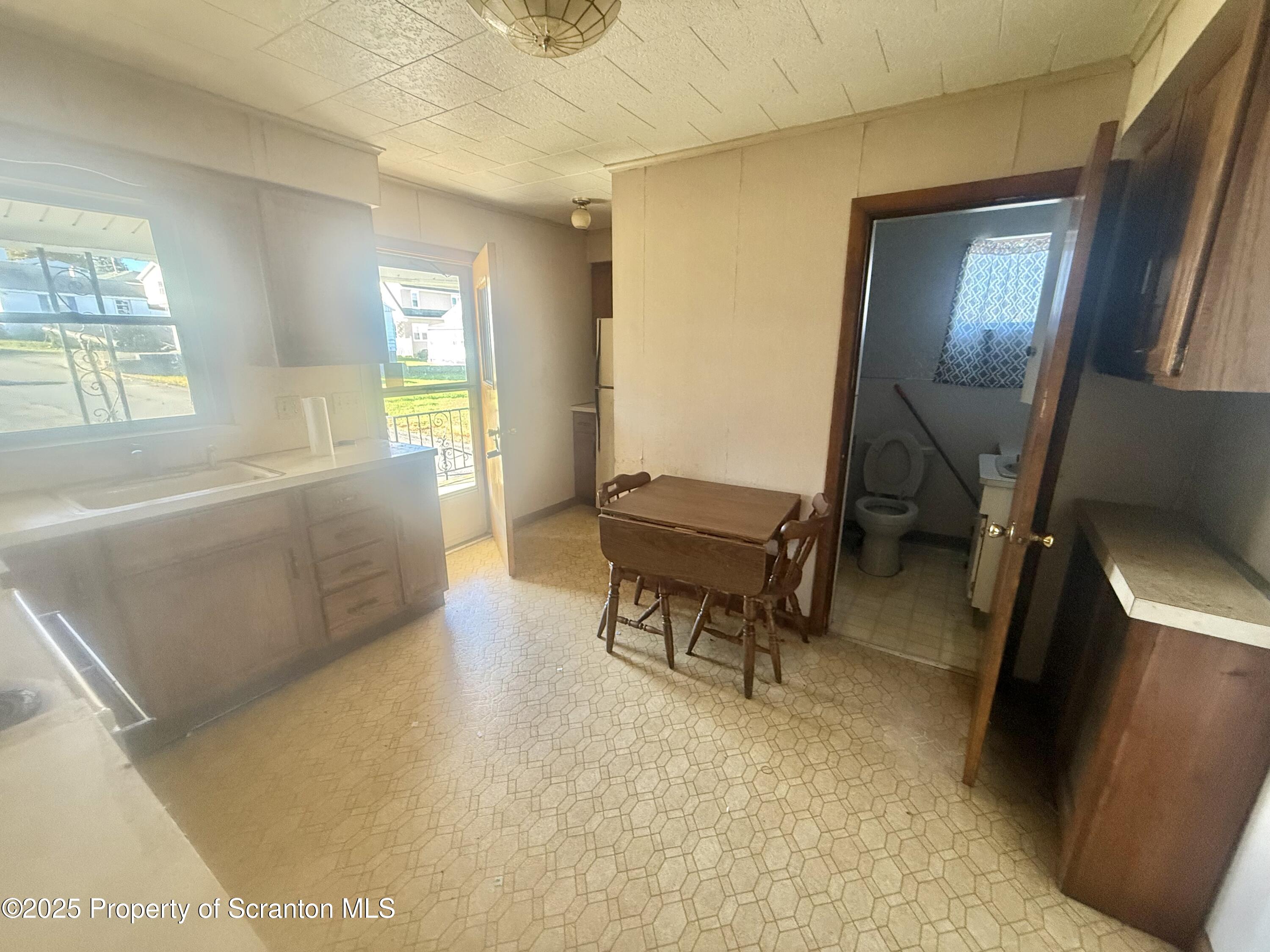 662 Simpson Street Throop, PA 18512 - Photo 4 of 9 a living room with furniture and a window